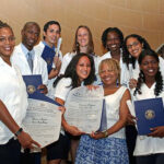 First class of US graduates of ELAM showing their degrees